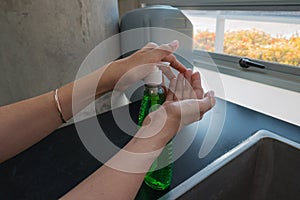 Female hand-pumped bottle of liquid soap in the public area. Prevention and Control of Coronavirus Outbreaks