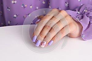 Female hand with purple manicure nails