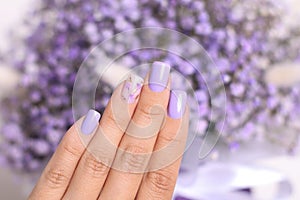 Female hand with purple manicure nails