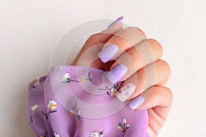 Female hand with purple manicure nails