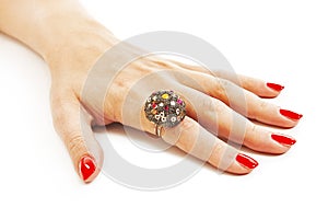 Female hand with red nails with ring