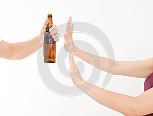 Female hand reject a bottle of beer isolated on white background.anti alcohol concept. Copy space