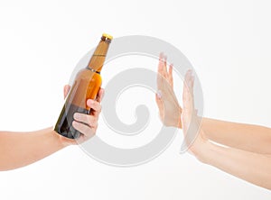 Female hand reject a bottle of beer isolated on white background.anti alcohol concept. Copy space