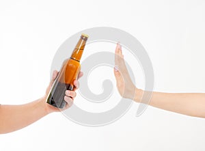 Female hand reject a bottle of beer isolated on white background.anti alcohol concept. Copy space