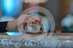 Female hand ring bell on hotel reception desk Ai photo