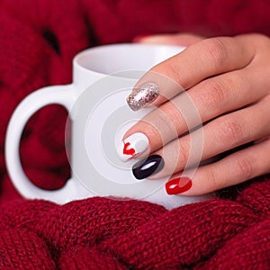Female hand with romantic manicure nails, heart design