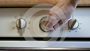 A Female Hand Sets the Time, Mode, Cooking Temperature on a Modern Oven, Stove