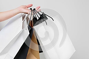 Female hand with shopping bags on white background isolated