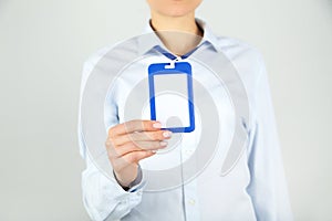 Hand showing blank white bagde photo