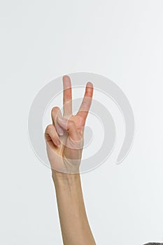 Female hand showing peace sign or victory sign