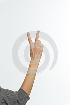 Female hand showing peace sign or victory sign