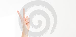 Female hand showing the sign of victory or peace closeup isolated on white background.Front view. Mock up. Copy space. Template