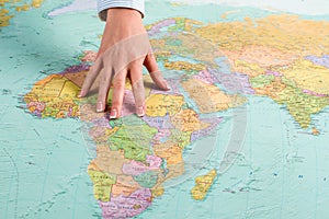 Female hand shows African continent.