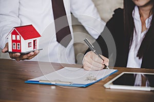 Female hand signing business document