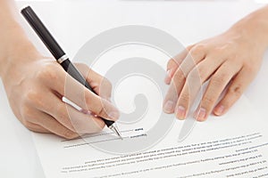 Female hand signing contract. photo