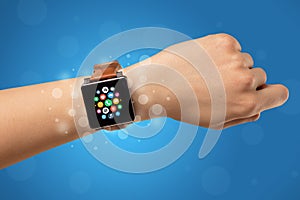 Female hand with smartwatch and app icons