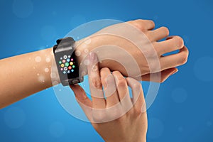 Female hand with smartwatch and app icons