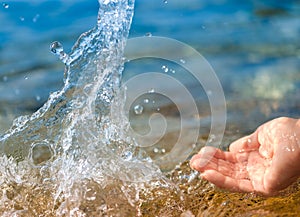 Female hand splashing clean water photo