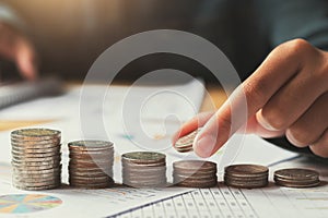 female hand stack coins to show for business accounting concept