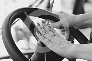 Female hand on the steering wheel