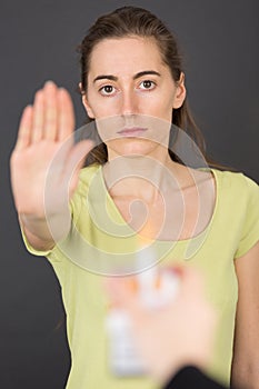 Female hand stop sign on grey background