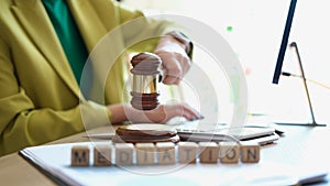 Female hand striking gavel in court room