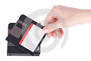 Female hand takes a floppy disk