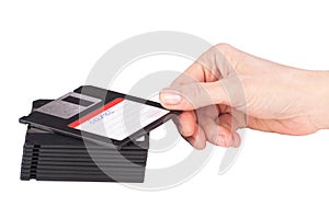 Female hand takes a floppy disk
