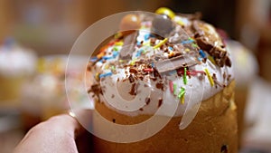 Female Hand Takes One Easter Cake, Decorated with Colorful Powder, Confetti. 4K