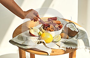 Female hand takes a piece of pastilles from a bowl