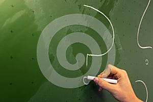 Female Hand Teacher Writing on Green Chalkboard Professor University White Chalk College Education Lesson Question Mark