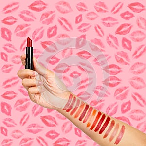 Female hand testing different lipsticks, showing swatches