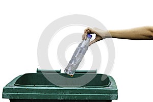 Female hand throwing empty plastic bottle into the trash.