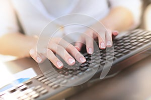 Female hand touching buttons of computer keyboard