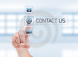 Female hand touching contact us button