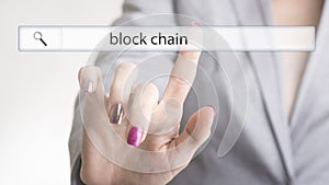 Female hand touching a web search bar with the word block chain