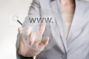 Female hand touching a web search bar with www and magnifying glass icon