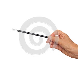 Female hand with traditional magician`s black and white magic wand isolated on white background.