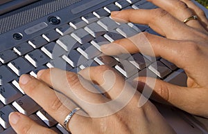 Female hand typing on laptop