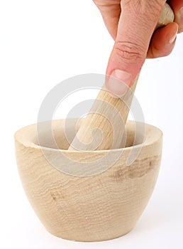 Female hand using a mortar and pestle