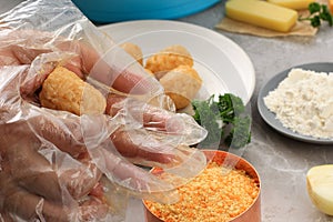 Female Hand Using Plastic Gloves Making Arancini, Rounding Rice Arancini