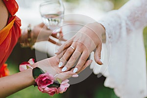 Female hand with wedding ring, bridesmaids