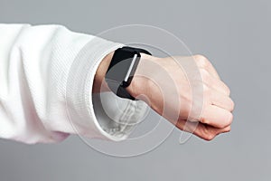Female hand in white sleeve with smartwatch are showing heart ra