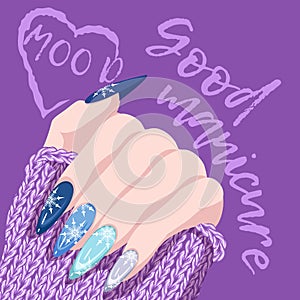 Female hand with winter manicure with snowflakes and a warm knitted sweater isolated on a white background.