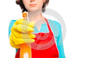 Female hand in yellow glove directs the cleaning spray photo