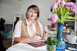 Female handcrafter posing for the camera in her workshop