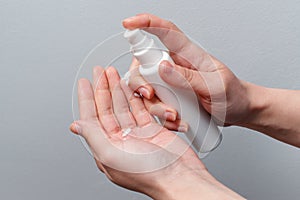 Female hands applying antibacterial liquid soap close up