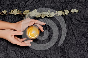 Female hands with aromaric scented candle. Spa