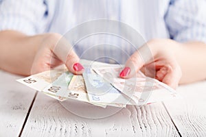 Female hands with banknotes give money