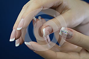 Female hands with beautiful french manicure with decotations. photo